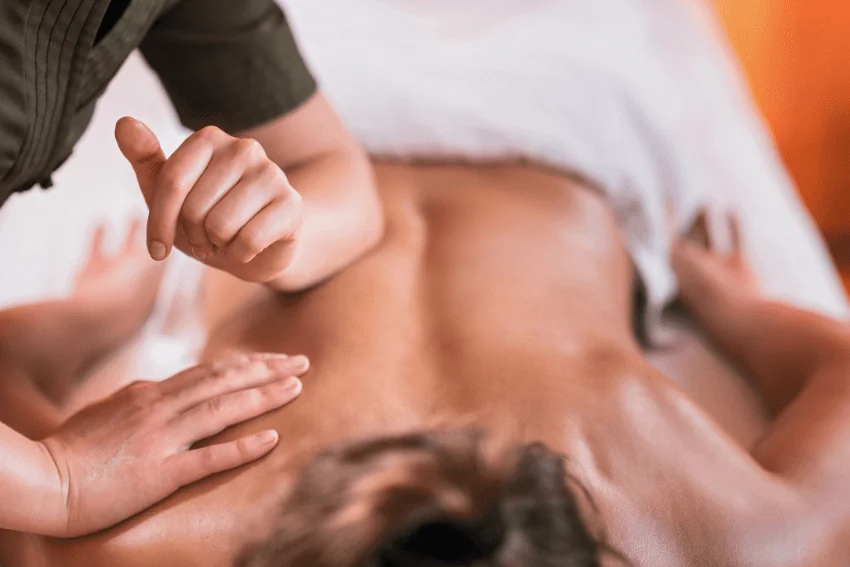 Deep tissue massage using elbow technique at Wellspring Health and Wellness